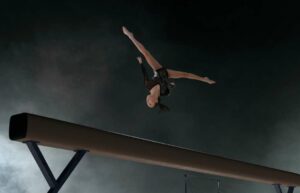 Gymnast performing a flip on a beam