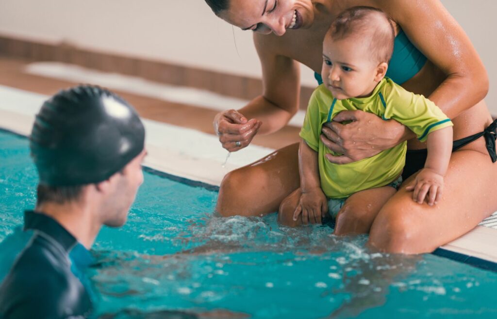 Baby in a swim school class